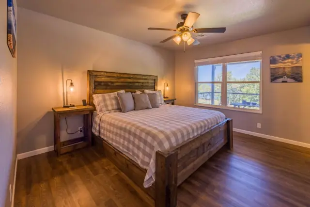 Master bedroom with king bed and rustic wood frame